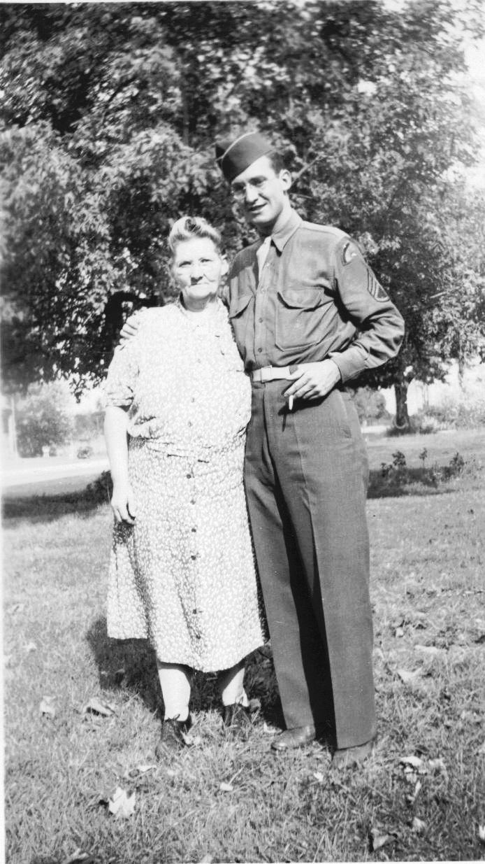 Staff Sergeant Graydon Waters with his arm around his mother on a summer lawn in New York, the last photograph taken before he was killed at Hatten